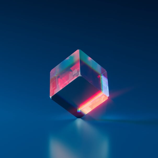 a glass cube standing on one corner, reflecting red light