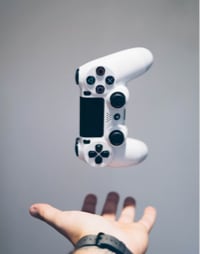 A hand tossing a gaming pad.